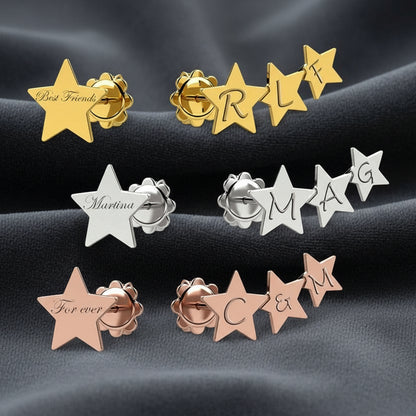 Orecchini a cerchio Art MiD con pendente a stella e nome personalizzato in argento 925 su velluto grigio antracite a onde.